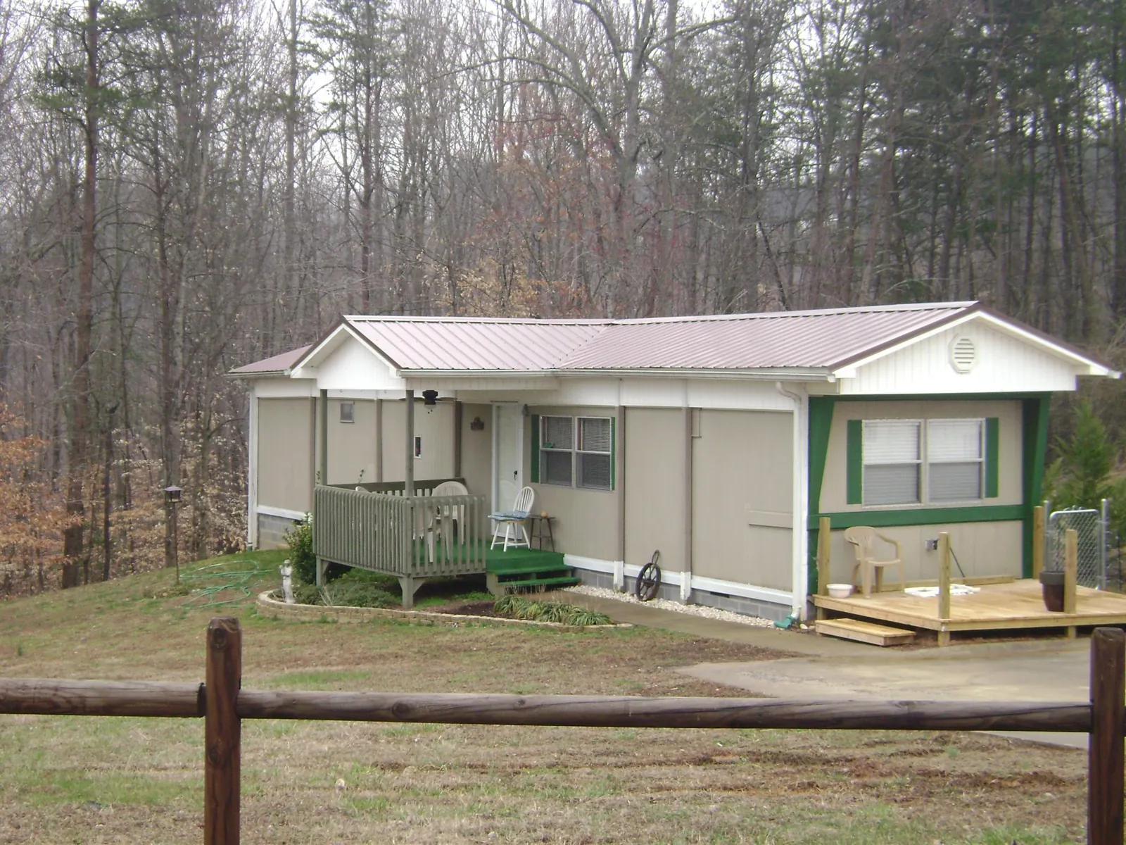 Mauve metal roof on a manufactured home with a new front deck in Mutual